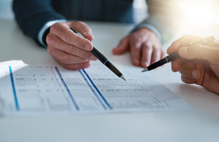 people with paperwork for asset management in office