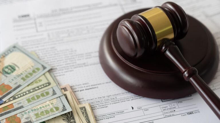 judge gavel and money on tax form