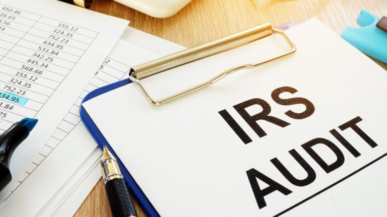 IRS audit documents with clipboard on a desk