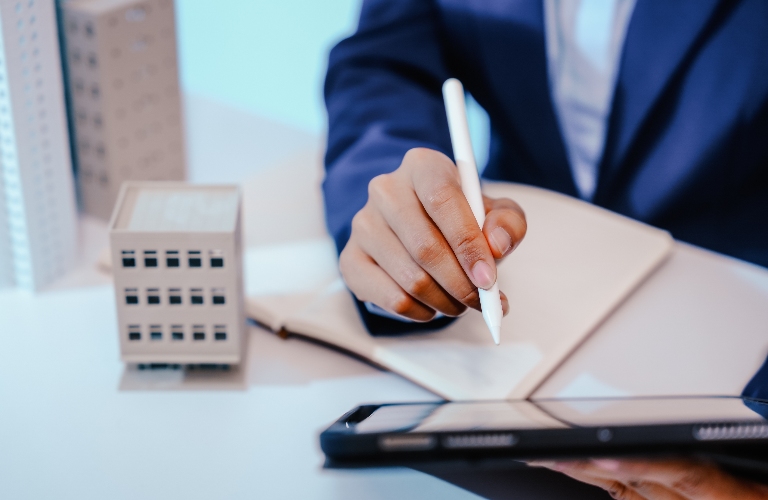 Lawyer is working with document near house model
