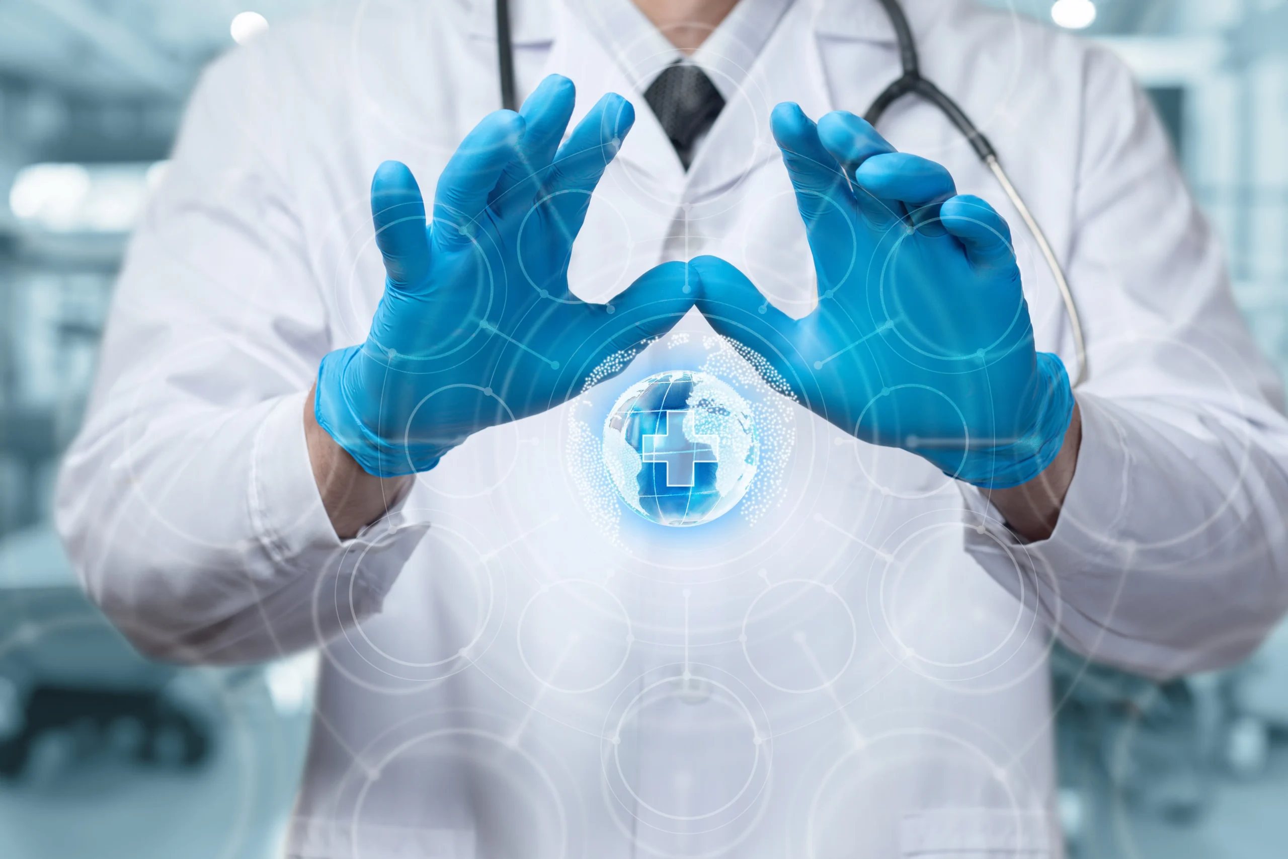 Medical professional in white coat and blue gloves holding digital globe with healthcare cross symbol.