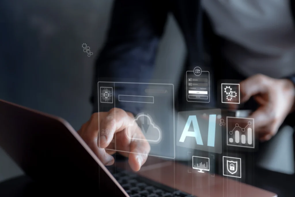 Person interacting with laptop displaying digital AI and cloud computing icons.